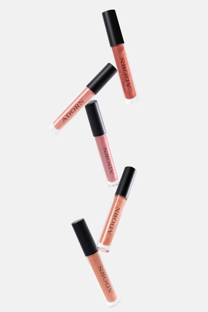 cosmetic lip gloss product photography with floating tubes on white background