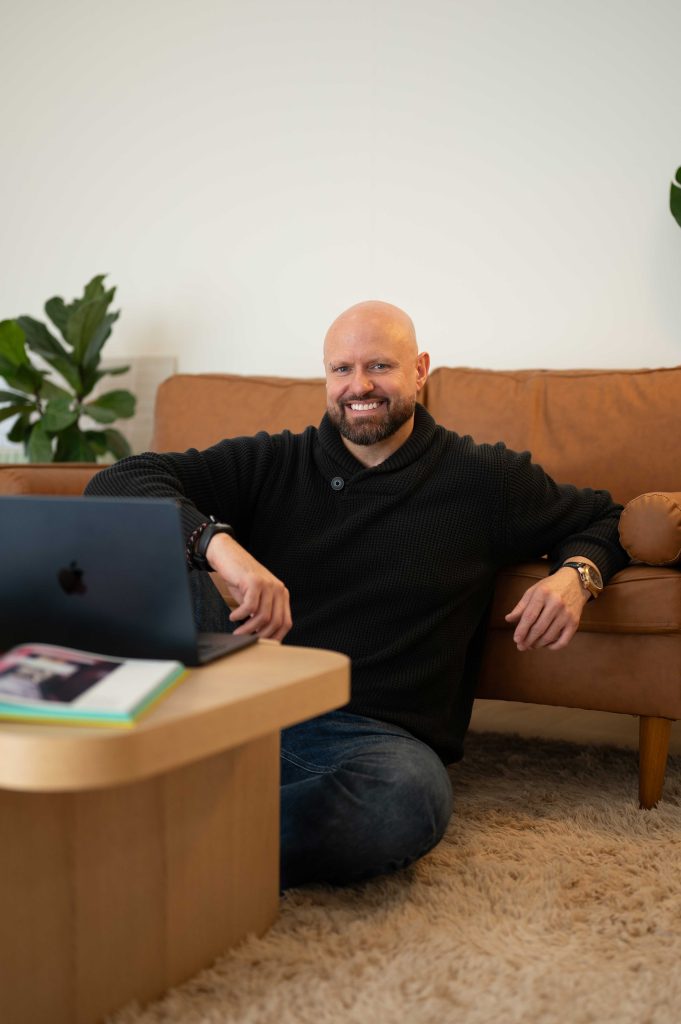 Man in black working on a laptop during a personal brand session in an Adelaide Hills studio