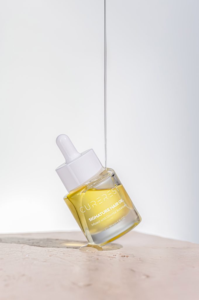 Product photography Adelaide by Mindful Creatives featuring skincare oil dropper with liquid texture in motion