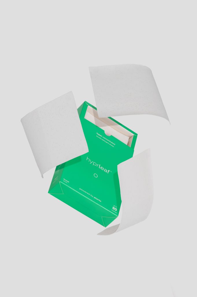 Clean product photography of home cleaning packaging with open container highlighting product form and design