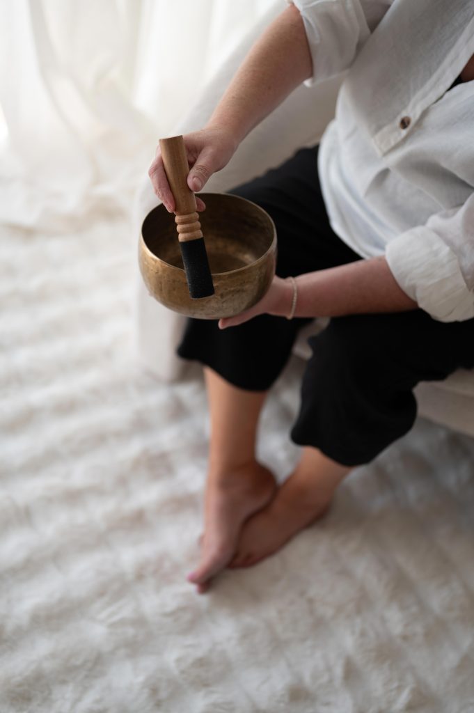Person holding a singing bowl during a personal brand session for a wellness business in Adelaide