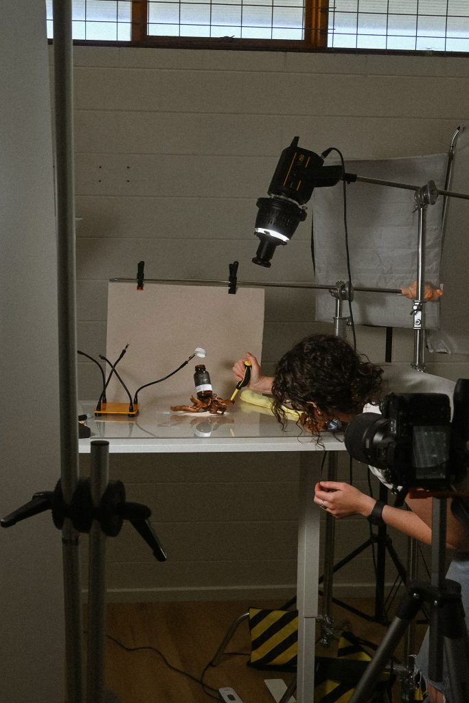 Lauren Edmond photographing a product setup in her commercial photography studio in the Adelaide Hills.