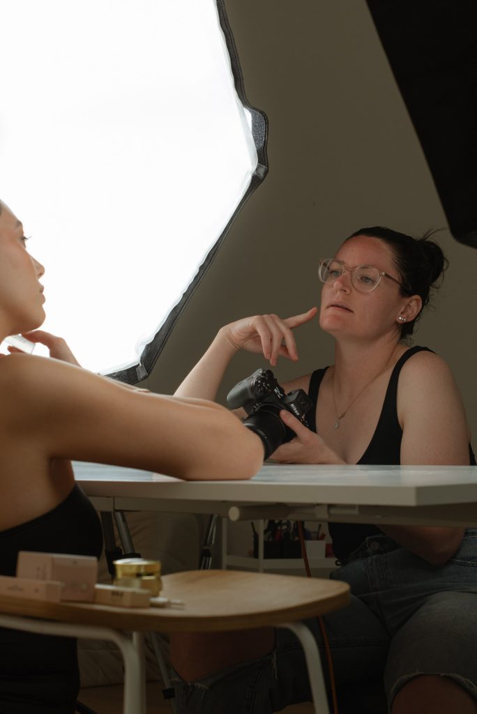 Product photographer planning and directing brand imagery in Adelaide Hills studio with professional lighting