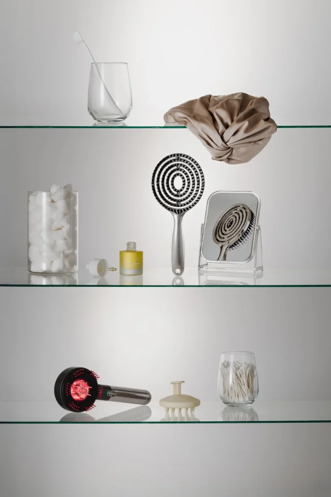 Curerest hair and scalp care products styled across glass bathroom shelves