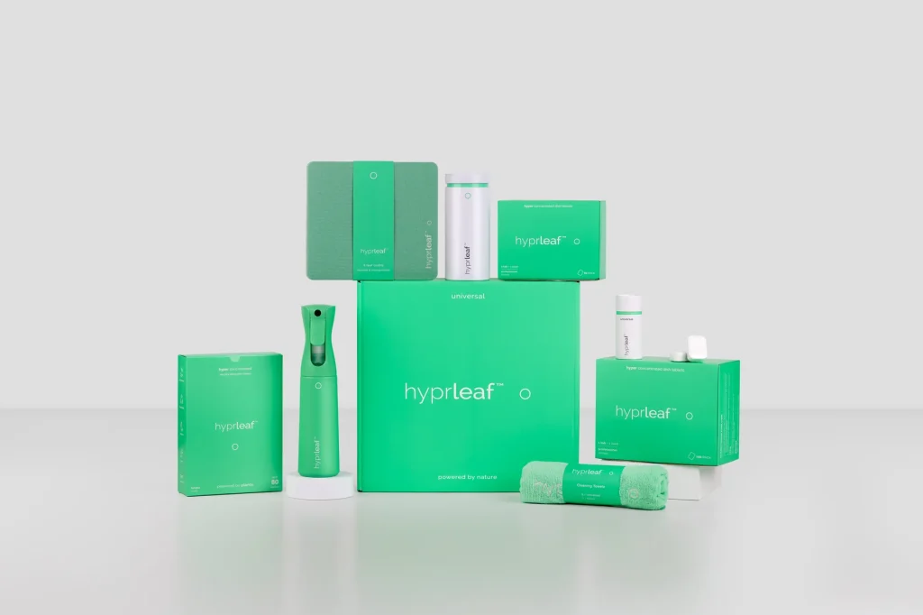 Full Hyprleaf product range with spray bottle, laundry sheets, dish tablets, refill canister, cloths, and towels on white