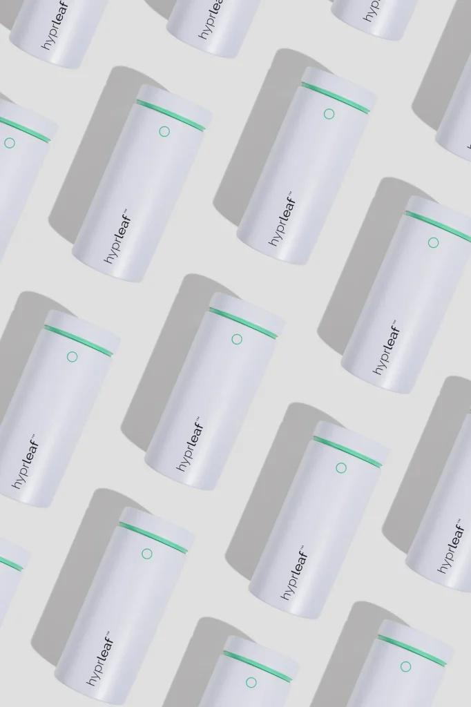 Repeating diagonal pattern of Hyprleaf white refill canisters on a grey background