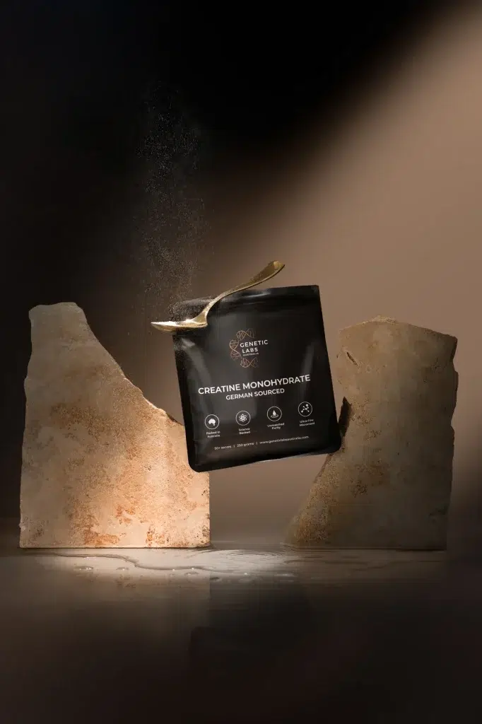 Genetic Labs Australia Creatine Monohydrate pouch between travertine stones with a gold spoon
