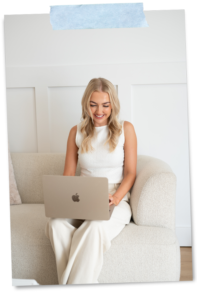 Woman smiling while working on a laptop during a Rapid Brand Session in an Adelaide Hills studio